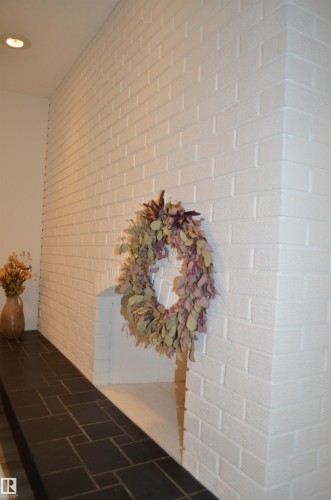 White textured brick hearth featuring a contrasting dark tile surround - 68 Marlboro Road, Edmonton, AB 
