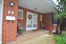 Brick exterior featuring a covered porch with a gravel-finish concrete surface - 68 Marlboro Road, Edmonton, AB 