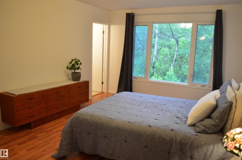 Hardwood flooring complements white walls and a large multi-pane window - 68 Marlboro Road, Edmonton, AB 