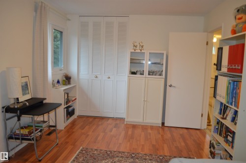 Light-filled room featuring wood-finish flooring and a window with white trim - 68 Marlboro Road, Edmonton, AB 