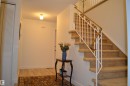 Carpeted staircase featuring a decorative white and brass railing - 68 Marlboro Road, Edmonton, AB 