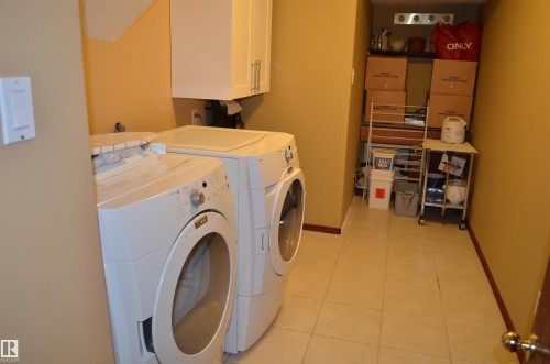 Dedicated laundry area featuring a front-loading washing machine and dryer - 68 Marlboro Road, Edmonton, AB 