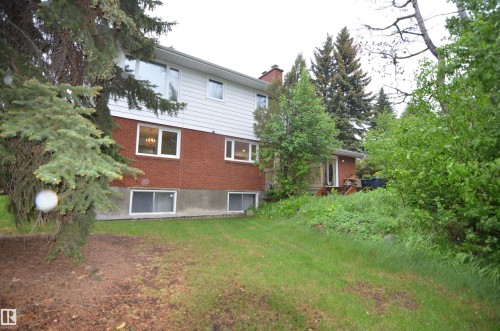 Split-level residence featuring a brick and siding exterior, multiple windows, and a rear deck - 68 Marlboro Road, Edmonton, AB 
