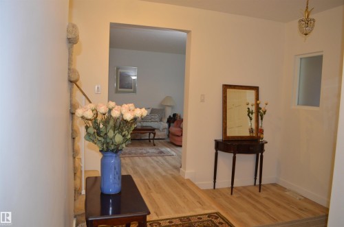Entryway featuring light wood-finish flooring and neutral wall tones - 68 Marlboro Road, Edmonton, AB 