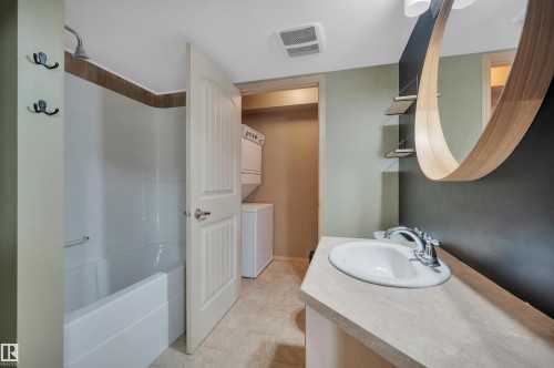 Bathroom featuring a white bathtub and shower combination with a brown tiled surround - 40 604 62 Street, Edmonton, AB 