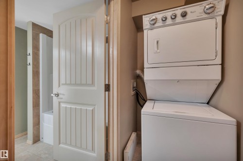 Integrated laundry area featuring a stacked washer and dryer unit - 40 604 62 Street, Edmonton, AB 