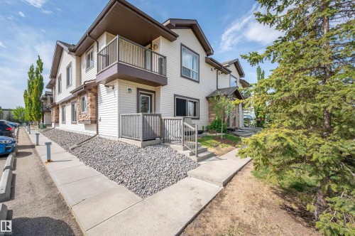 Multi-story townhouse exterior featuring light-colored siding with stone accents - 40 604 62 Street, Edmonton, AB 