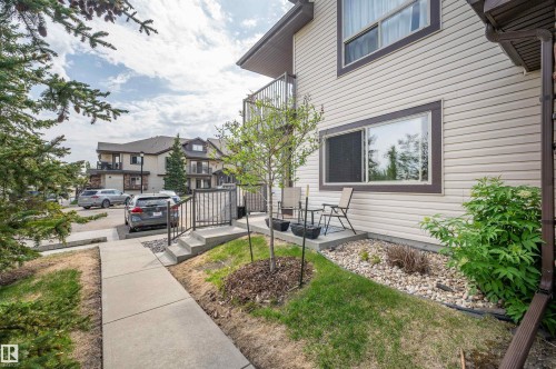 Ground-level patio area featuring a concrete slab and surrounding landscaping with gravel and shrubbery - 40 604 62 Street, Edmonton, AB 