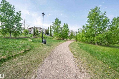 Gravel pathway surrounded by mature trees and grassy areas - 40 604 62 Street, Edmonton, AB 