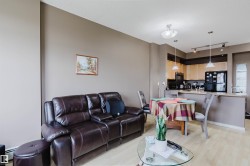 Open-concept living space featuring wood-finish flooring throughout - 