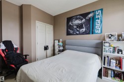 Bedroom featuring a paneled closet door and neutral wall tones - 