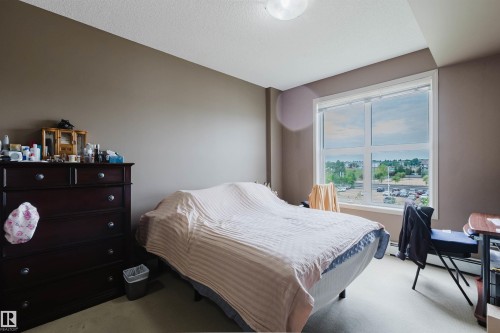 Bright room featuring a large window, neutral wall paint, and overhead lighting - 1-405 4245 139 Avenue, Edmonton, AB 