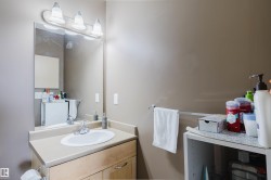 Bathroom vanity with an integrated sink, laminate countertop, and wood-finish cabinetry - 