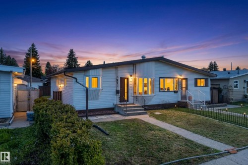 Single-story residence featuring white siding and a dark roofline - 6203 90 Avenue, Edmonton, AB 