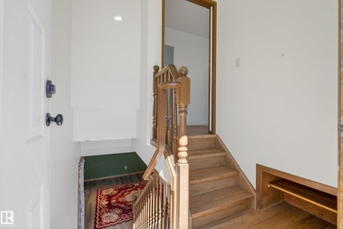 Solid wood staircase with turned newel posts and spindles - 6203 90 Avenue, Edmonton, AB 