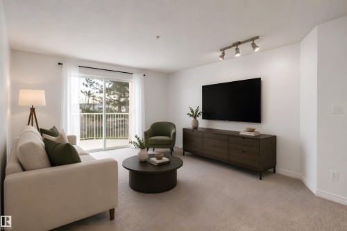 Living area with light-toned carpeting and white walls - 320 245 Edwards Drive, Edmonton, AB 