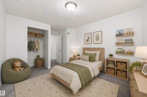 Carpeted room with a built-in closet featuring a single shelf and hanging rod - 320 245 Edwards Drive, Edmonton, AB 
