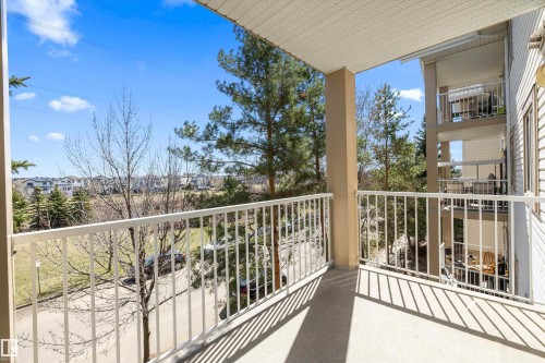 Balcony with concrete flooring and white metal railings - 320 245 Edwards Drive, Edmonton, AB 