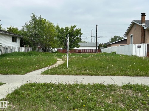 Residential lot featuring a concrete sidewalk and established greenery - 10716 131A Avenue, Edmonton, AB 