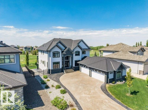 Contemporary architectural design featuring a multi-gabled roofline and a patterned driveway - 328 52327 Range Rd 233, Rural Strathcona County, AB 