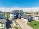 Contemporary architectural design featuring a multi-gabled roofline and a patterned driveway - 328 52327 Range Rd 233, Rural Strathcona County, AB 