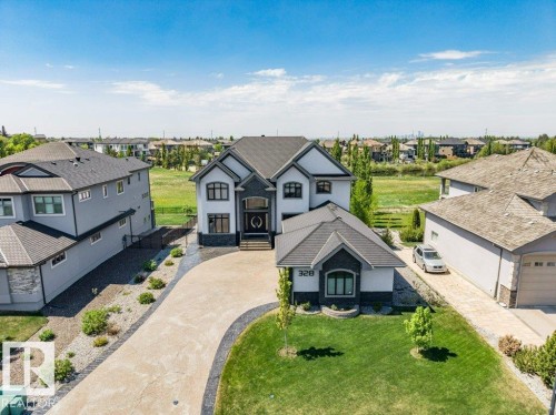 Modern architecture with contrasting dark gray and white siding - 328 52327 Range Rd 233, Rural Strathcona County, AB 