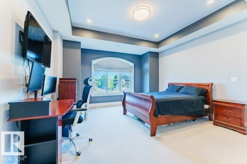 Room with tray ceiling, recessed lighting, and a prominent arched window - 328 52327 Range Rd 233, Rural Strathcona County, AB 