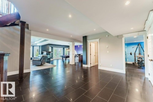 Spacious interior featuring dark tile flooring and recessed lighting throughout - 328 52327 Range Rd 233, Rural Strathcona County, AB 