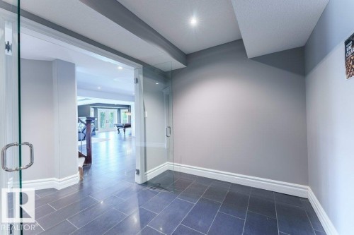 Entryway featuring slate tile flooring, white baseboards, and neutral wall tones - 328 52327 Range Rd 233, Rural Strathcona County, AB 