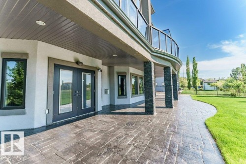 Covered patio with stamped concrete flooring - 328 52327 Range Rd 233, Rural Strathcona County, AB 