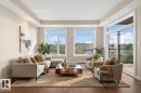Contemporary living area featuring rich wood-finish flooring - 309 625 Leger Way, Edmonton, AB 