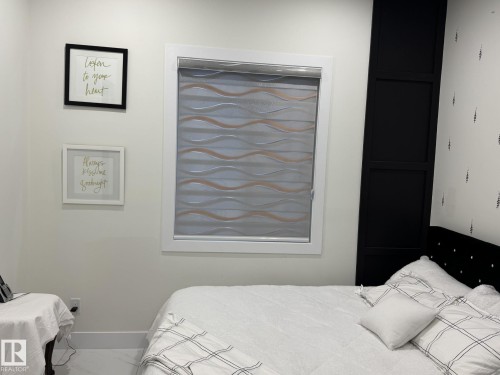 White-framed window with patterned roller shade - 2123 18 Avenue, Edmonton, AB 