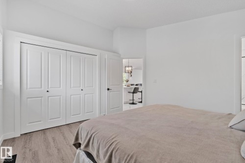 Bedroom featuring light wood-finish flooring and white walls - 1 Hunt Court, St. Albert, AB 