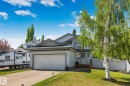 Light gray siding exterior with dark trim accents, featuring a prominent attached garage - 1 Hunt Court, St. Albert, AB 