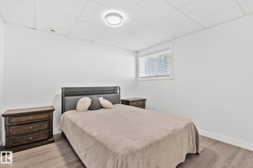 Room featuring wood-finish flooring, white walls, and a drop ceiling with recessed lighting - 1 Hunt Court, St. Albert, AB 