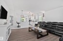 Open-concept living space featuring wood-finish flooring, vaulted ceilings, and recessed lighting - 1 Hunt Court, St. Albert, AB 