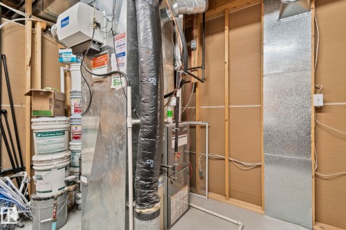 HVAC system featuring a humidifier unit, exposed ductwork, and electrical conduits - 1 Hunt Court, St. Albert, AB 