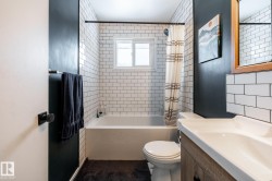 Professionally remodelled bathroom with vanity and shower/bath combo with shower curtain - 