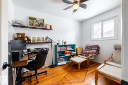 Second bedroom also serves as a home office with light flooring and ceiling fan - 