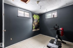 Exercise room featuring light flooring and baseboards - 