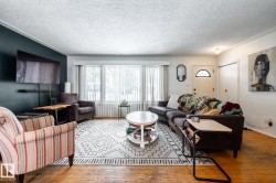 West-facing living room with hardwood flooring and a textured ceiling - 