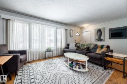 Living room featuring light wood finished floors and a textured ceiling - 