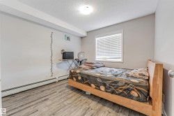 Neutral wall paint, wood-finish flooring, and a single window with blinds - 