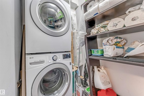 Stackable LG washer and dryer unit with front-loading design, digital controls, and a silver finish - 320 534 Watt Boulevard, Edmonton, AB - Indoor Photo Showing Laundry Room