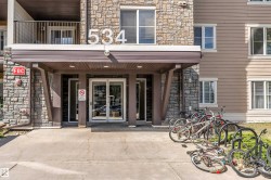 Building entrance featuring stone veneer and horizontal siding - 