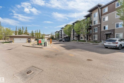 Multi-story residential building with contemporary siding and stone accents - 320 534 Watt Boulevard, Edmonton, AB - Outdoor