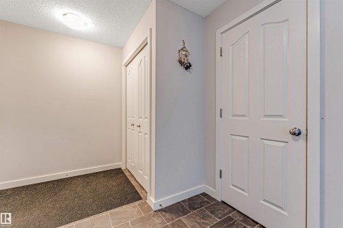 Entryway featuring neutral wall tones, white trim, and a flush-mount ceiling light - 320 534 Watt Boulevard, Edmonton, AB - Indoor Photo Showing Other Room