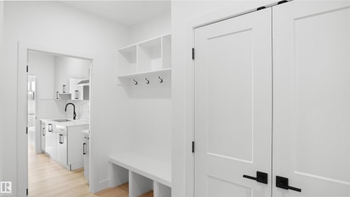Built-in storage bench with overhead shelving and coat hooks - 803 30 Avenue, Edmonton, AB 