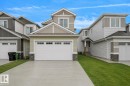 Contemporary exterior featuring light green siding and stone accents - 803 30 Avenue, Edmonton, AB 