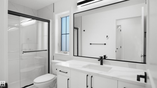 Modern bathroom featuring a single vanity with stone countertop, integrated rectangular sink, matte black faucet, and white cabinetry with matte black pulls - 803 30 Avenue, Edmonton, AB 